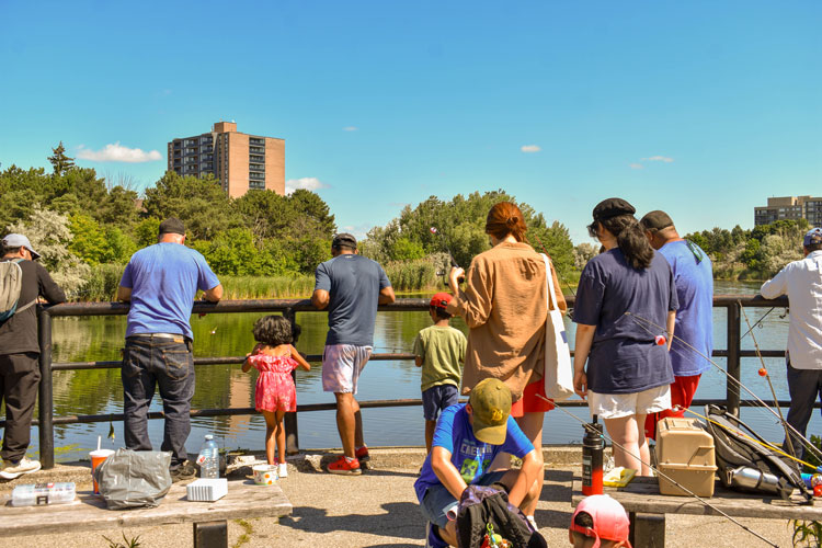 Families fishing at Lake Aquitaine on Family Fishing Day