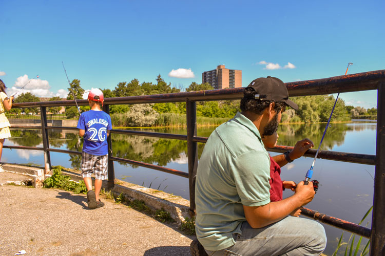 Families fishing at Lake Aquitaine on Family Fishing Day