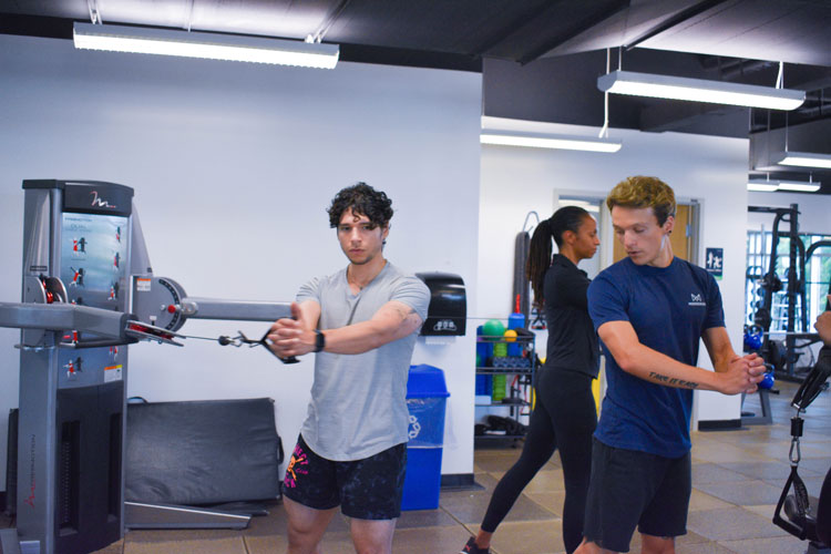 Trainer demonstrating exercise to group at the fitness centre at the Paramount Fine Foods Centre