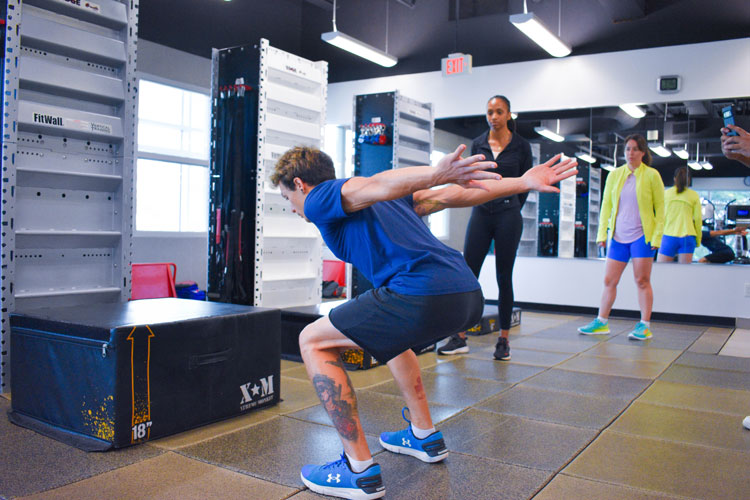 Trainer demonstrating box jumps to group fitness class at the fitness centre at the Paramount Fine Foods Centre